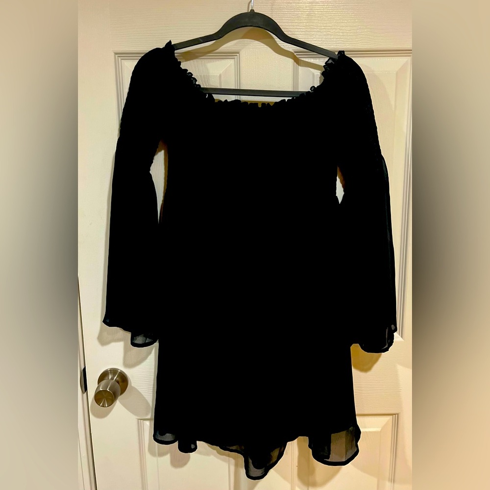 Black off the shoulder dress.